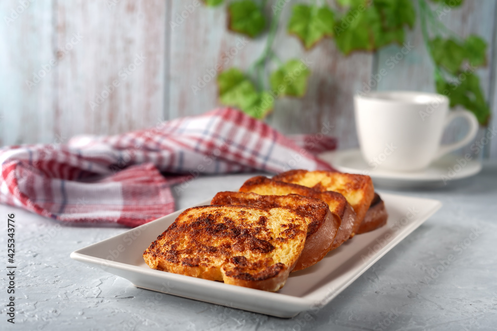 French toast with tea on a gray background. Healthy breakfast concept. French toast with tea on a gray background. Healthy breakfast concept.