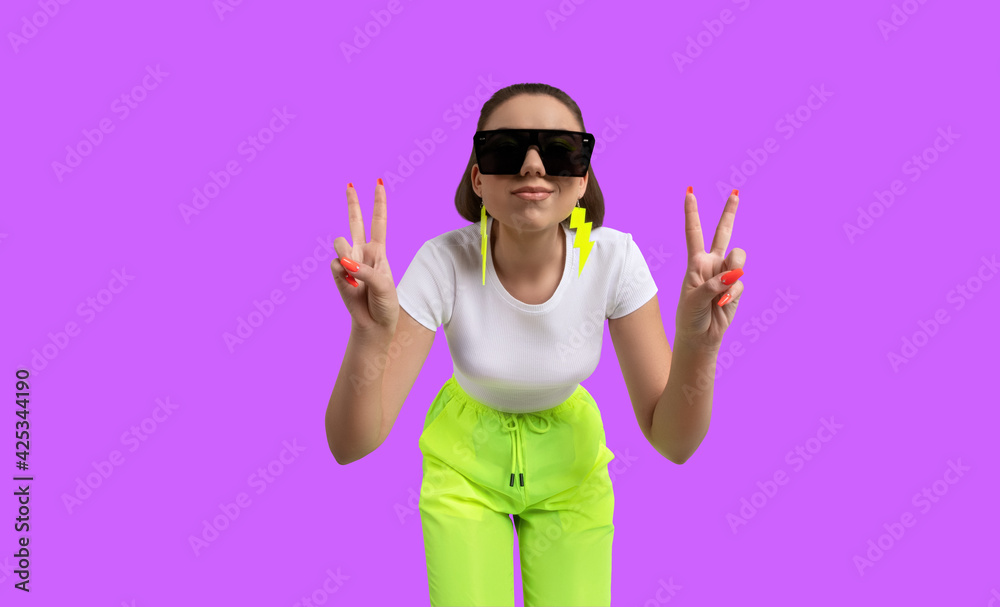 Girl in a white T-shirt and yellow neon sweatpants isolated on a colored background. Girl in a white T-shirt and yellow neon sweatpants isolated on a colored background.