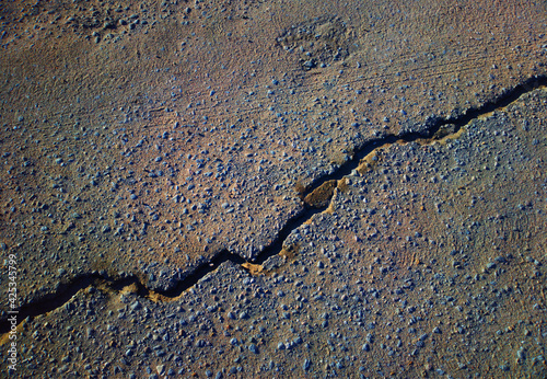 Cracked asphalt road texture background photo