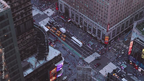 NYC: Times Square from above closeup shot of traffic, pedestrians, intersections, billboards and neon lights, looking at the base of the Paramount Building - New York City, USA