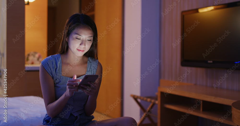 Woman check on smart phone at home in the evening Woman check on smart phone at home in the evening