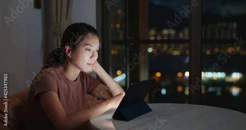 Canvas Print Woman use of tablet computer at night