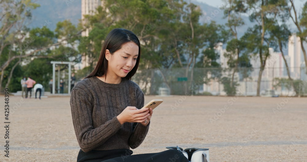 Woman check on cellphone at park Woman check on cellphone at park