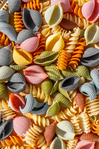 Different types of Italian colorful dry pasta as background. Macro close up