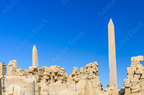 Granite obelisk against blue sky in a Karnak temple. Luxor, Egypt.