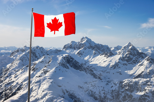 Canadian National Flag Overlay. Mountain Landscape in Winter. Bright Sunny Sky. Background from Tantalus Range near Squamish, North of Vancouver, British Columbia, Canada.