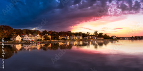 Panoramic view of residential homes by the Mystic River. Colorful Magical Sunrise Sky Art Render. Taken in Mystic, Stonington, Connecticut, United States.