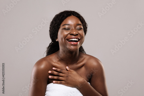 Enjoy Your Beauty. Closeup Of Positive Laughing Black Woman Wrapped In Towel