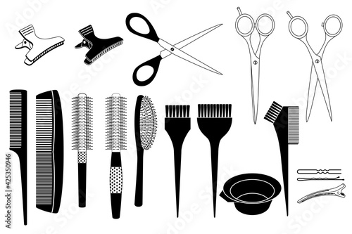 Ensemble d’objets noirs et blancs utilisés par les coiffeurs - peignes, brosses, ciseaux, pinces à cheveux.