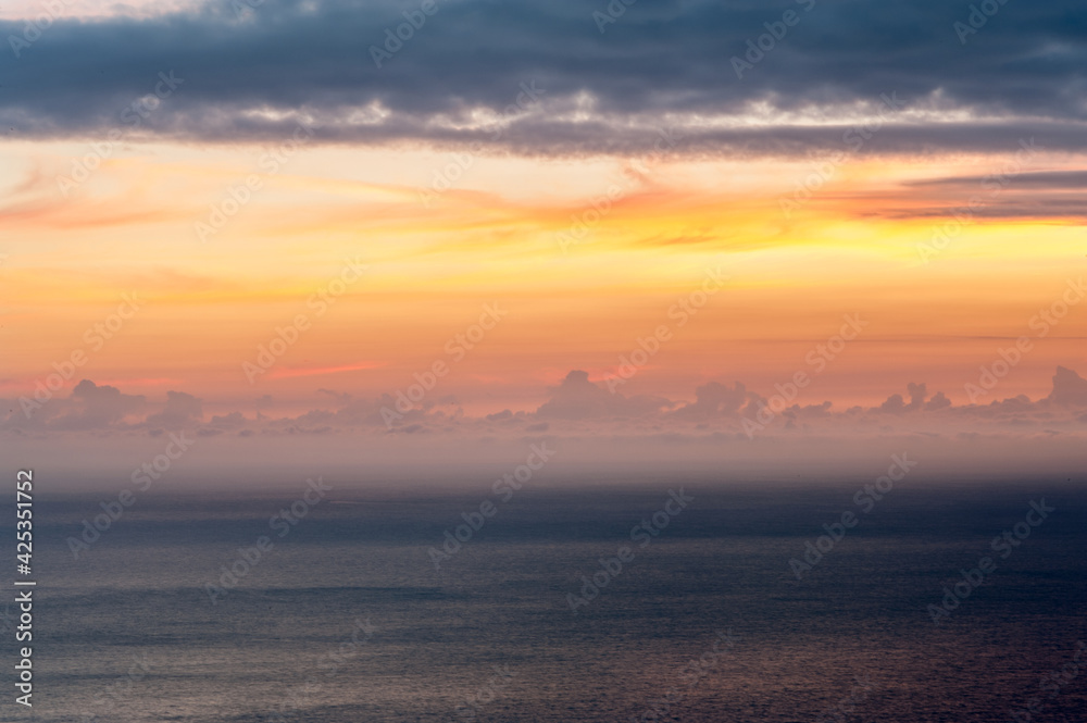 Landscape photography in which a winter sunrise is seen in the Mediterranean Sea from the coast of Alicante. Ideal for backgrounds. Space for text and presentations.