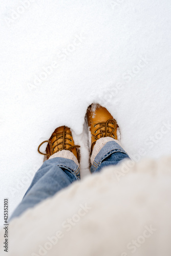 Boots in the snow, top view.