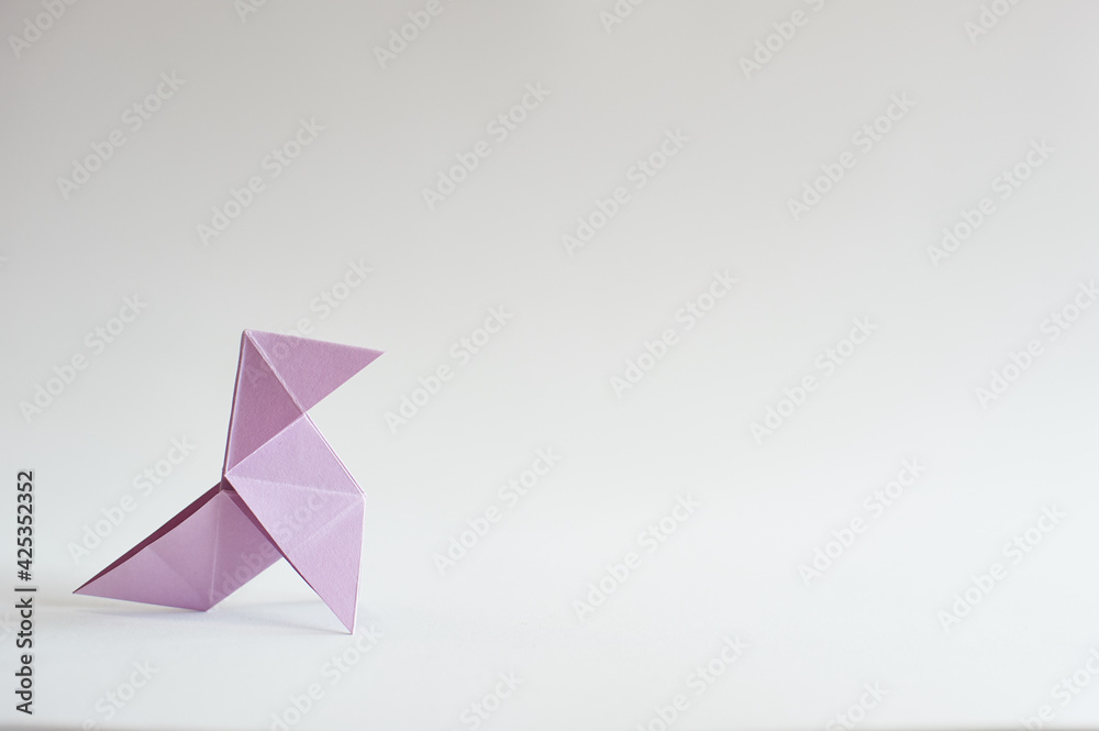 Photograph of a colored paper bow tie in front of a white background. Space for text. Background. For presentations Photograph of a colored paper bow tie in front of a white background. Space for text. Background. For presentations