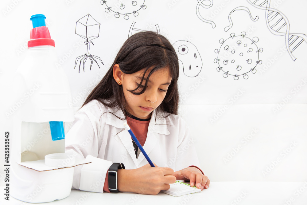 Naklejka premium Young girl playing a life sciences professional role. Could be biologist, doctor, researcher. Dreaming about the future.