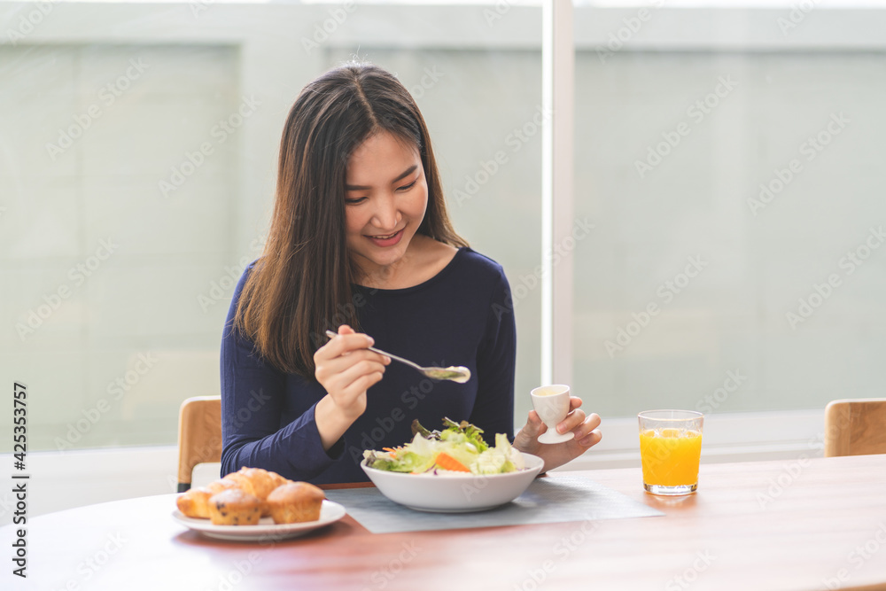 Portrait of happy playful asian girl eating fresh salad in diet concept Portrait of happy playful asian girl eating fresh salad in diet concept