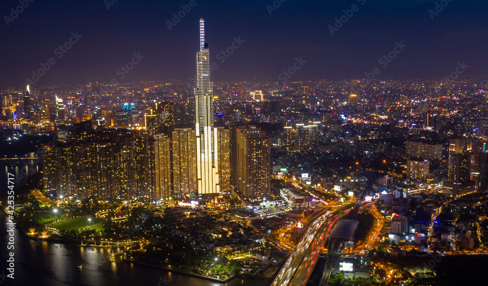 Obraz premium pic evening aerial panorama of Saigon, Ho Chi Minh City, Vietnam featuring all key buildings of the city skyline and the Saigon riverfront with beautiful light reflections on the calm water