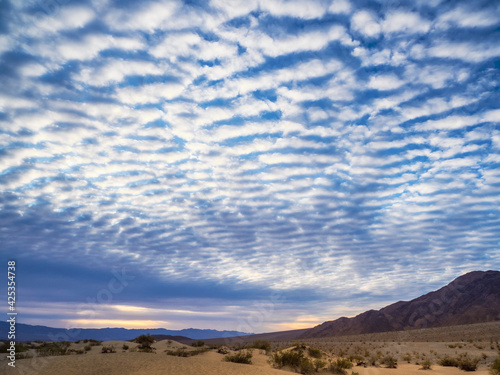 Dramatic sunrise clouds and sand dunes at Death Valley National Park