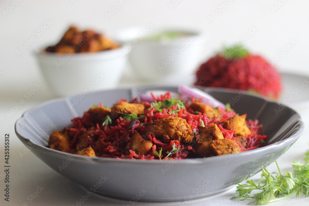 Beetroot pulao, a one pot rice preparation with basmati rice, beetroot, onions and spices. Served with air fried chicken bites and curd. Beetroot pulao, a one pot rice preparation with basmati rice, beetroot, onions and spices. Served with air fried chicken bites and curd.