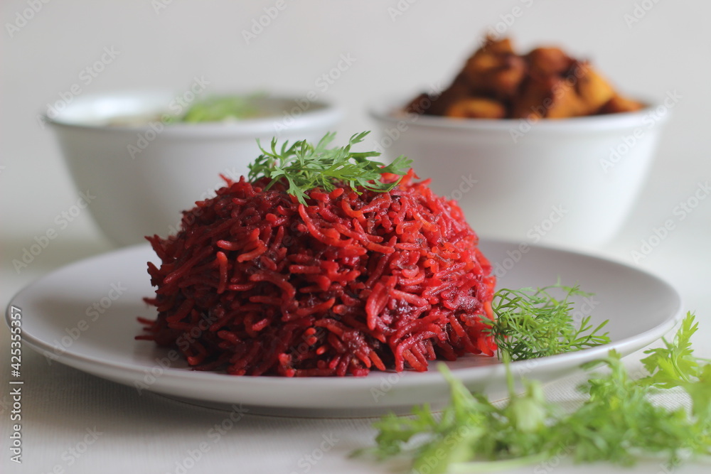 Beetroot pulao, a one pot rice preparation with basmati rice, beetroot, onions and spices. Served with air fried chicken bites and curd. Beetroot pulao, a one pot rice preparation with basmati rice, beetroot, onions and spices. Served with air fried chicken bites and curd.