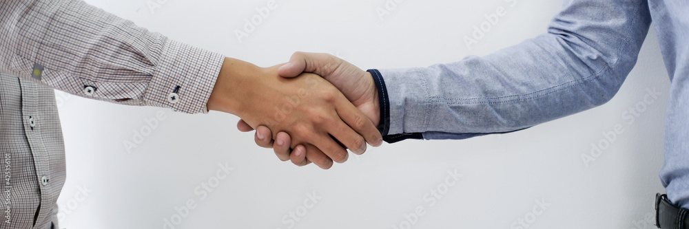 Businessman shaking hands successful making a deal. mans handshake. Business partnership meeting concept. - obrazy, fototapety, plakaty 