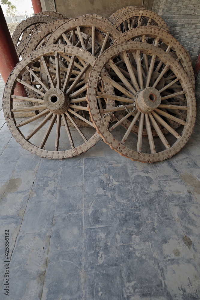 Old cart wheels piled together-DafoSi Great Buddha Temple compound. Zhangye-Gansu-China-1276