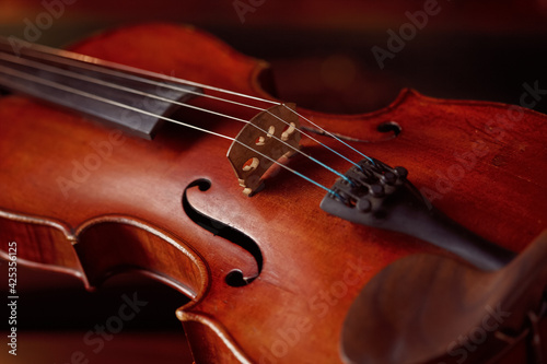 Violin in retro style and bow on wooden table