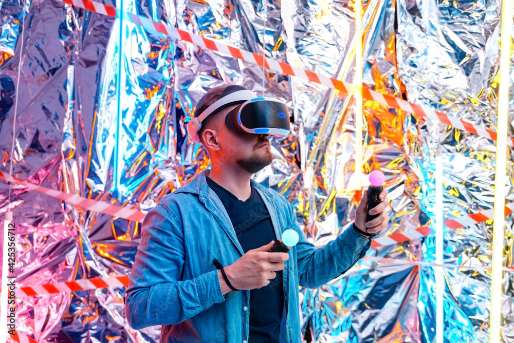 Obraz premium a young man in a VR helmet, VR glasses augmented virtual reality in the style of cyberpunk. 3d vision technology