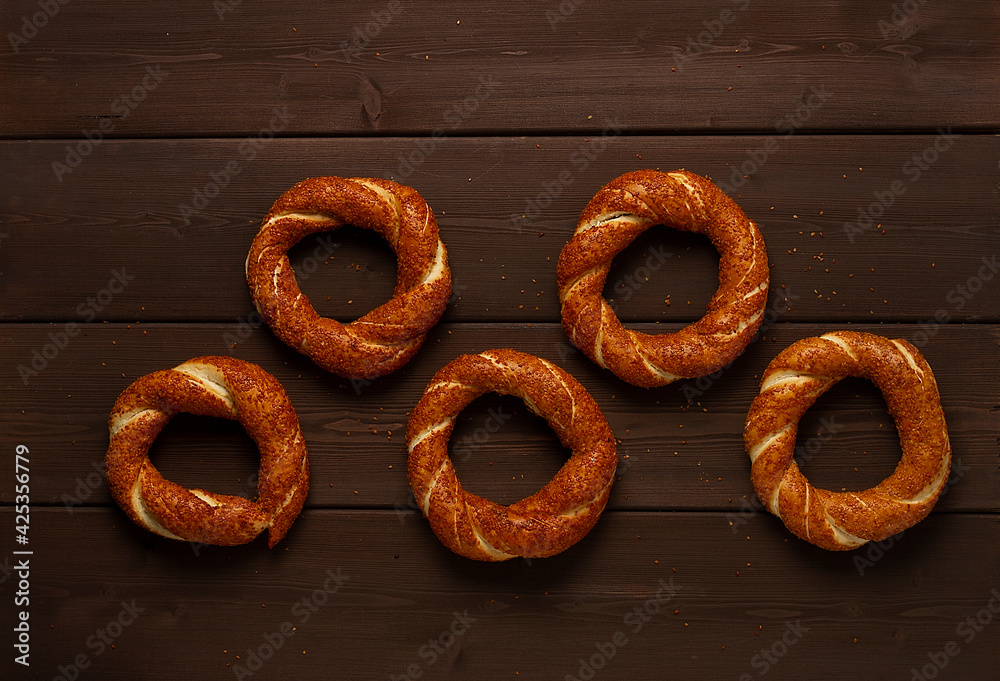 Traditional Turkish bagel simit, breakfast, on a wooden table, rustic, horizontal, no people,