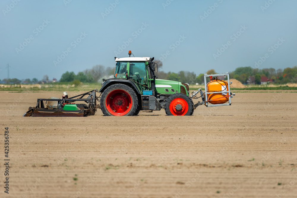 Tractor with weed burner in the field | 3364 Tractor with weed burner in the field | 3364