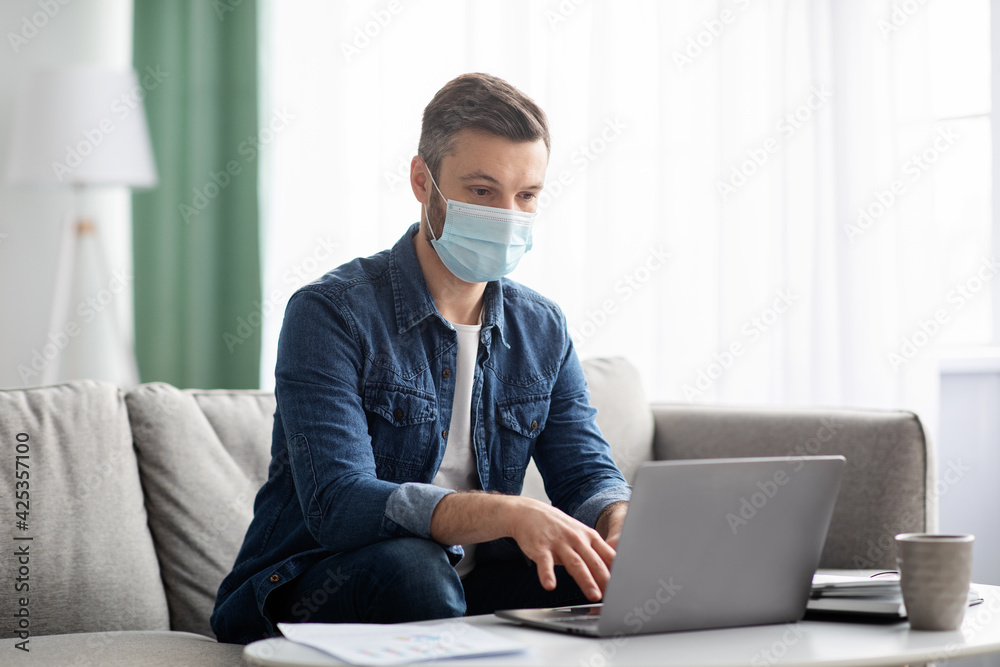 Man in face mask manager working from home