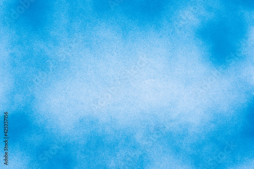 Abstract spray paint blue and white color on center on paper texture background © Kritchai