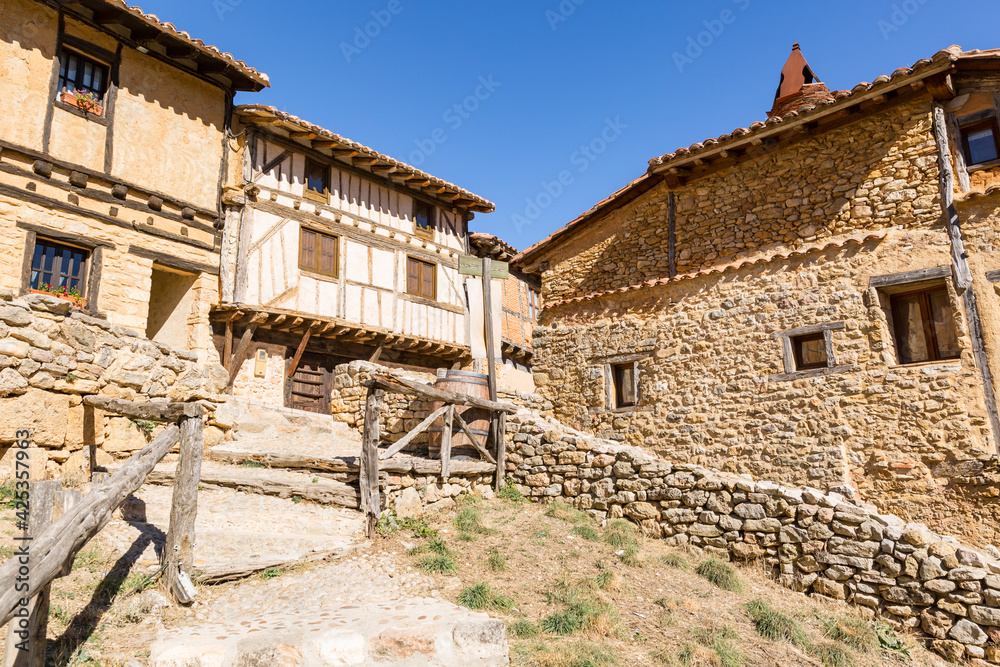 a street with traditional old houses in Calatanazor, province of Soria, Castile and Leon, Spain