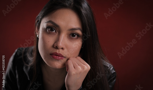 Sexy Asian woman in front of red velvet - studio photography