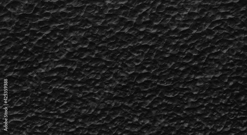 black textured spray paint for architectural facade finishing. grungy textured wall with light and shadow effect use as a background for design.