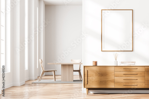 Bright living room interior with windows, two chairs and poster © ImageFlow