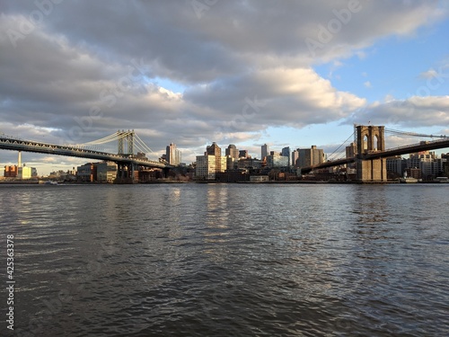 Fototapeta Naklejka Na Ścianę i Meble -  Evening sun over the Brooklyn & Manhattan Bridges, New York - March 2021