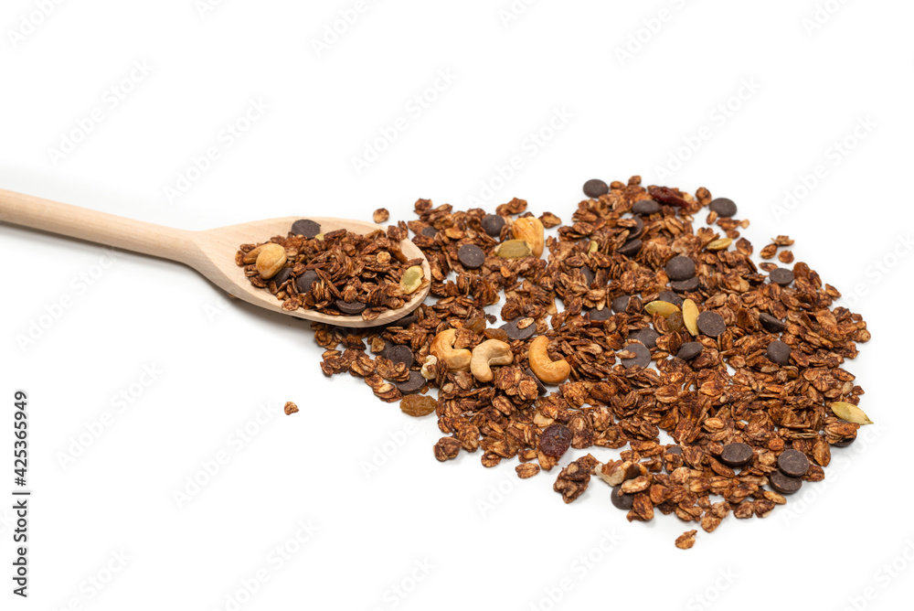 Chocolate granola cereal with nuts in a wooden spoon. Chocolate granola cereal with nuts in a wooden spoon.