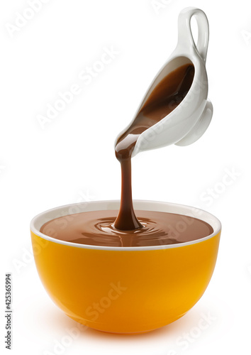 Pouring melted chocolate isolated on white background