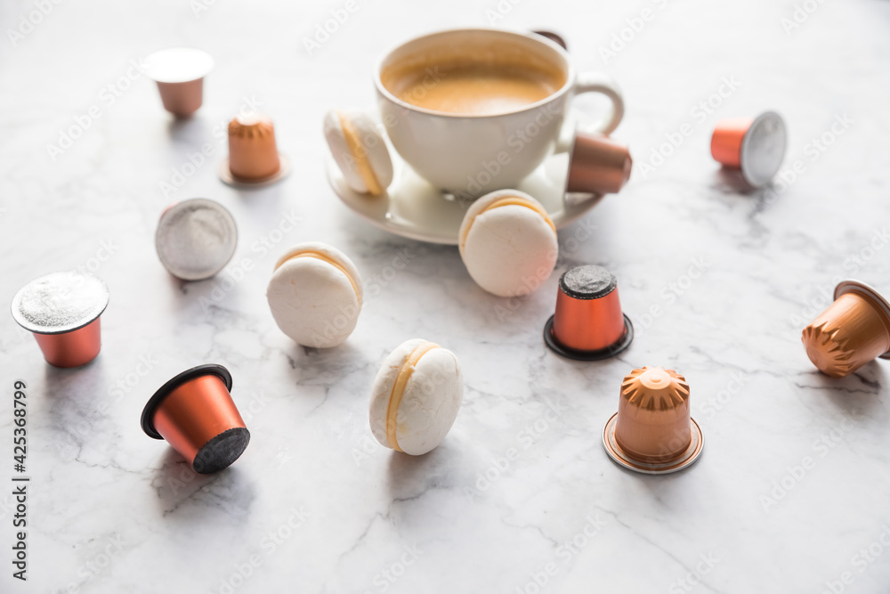 Cup of espresso, black coffee served with pods and capsules on marble table.Collection of espresso coffee capsules.Caffeine, hot drinks and objects concept.pods for coffee mashine Cup of espresso, black coffee served with pods and capsules on marble table.Collection of espresso coffee capsules.Caffeine, hot drinks and objects concept.pods for coffee mashine