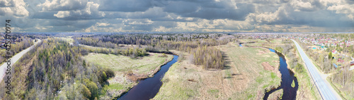 brown river between meadow and spring forest