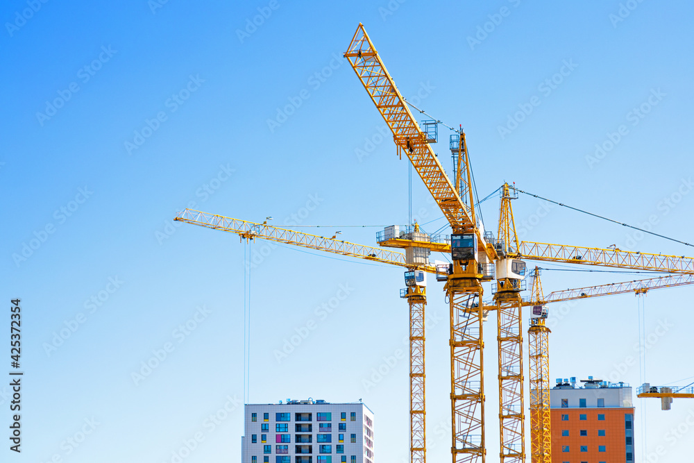 construction site with cranes on the background of the sky, construction of a new city area construction site with cranes on the background of the sky, construction of a new city area