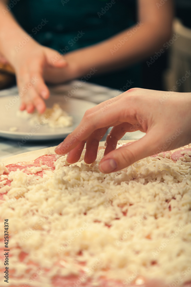 Preparing pizza for baking in the oven.