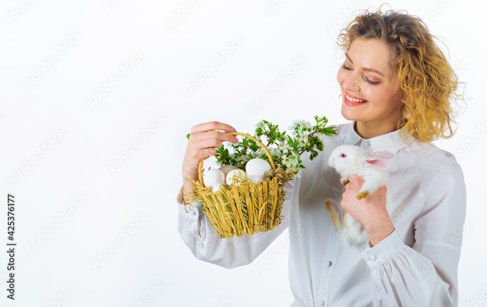 Smiling woman with Easter bunny rabbit and basket eggs. Religion symbol. Egg hunt. Spring holiday. Smiling woman with Easter bunny rabbit and basket eggs. Religion symbol. Egg hunt. Spring holiday.
