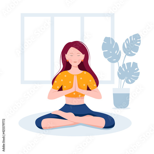 Girl meditates. A girl in a yoga pose sits on the floor.