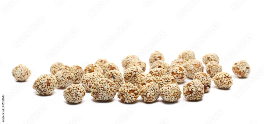 Caramelized hazelnuts ball with sesame seeds isolated on white background Caramelized hazelnuts ball with sesame seeds isolated on white background