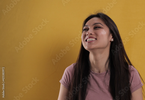 Portrait of a pretty girl against a yellow background - studio photography © 4kclips