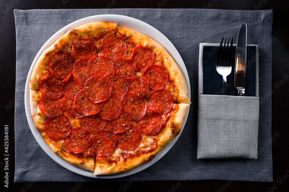 pepperoni pizza set table with knife and fork pepperoni pizza set table with knife and fork
