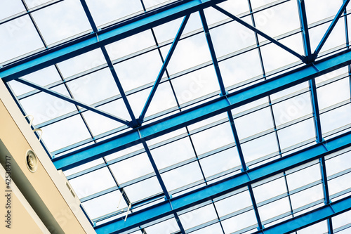 Fragment of a glass roof with metal beams in a shopping center. Close-up. Inside view