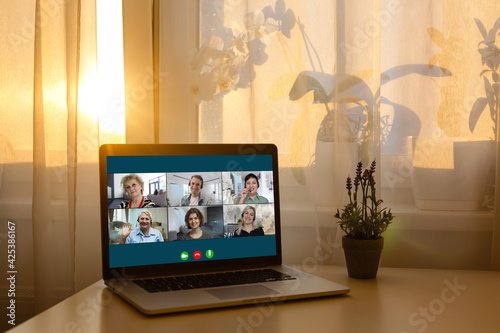 Virtual meeting online. Video conference by laptop. Online business meeting. On the laptop screen  people who gathered in a video conference to work on-line