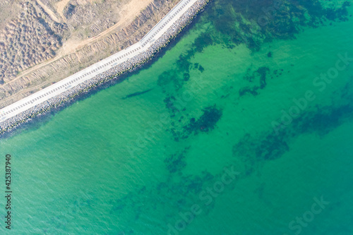 Seashore with turquoise water. Conceptual photo - sea and coast. Helicopter view.