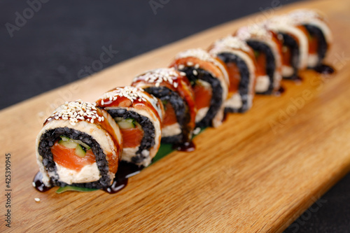 Seafood delicatessen salmon sushi black maki rolls